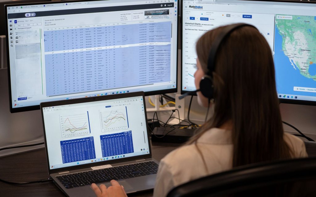 Woman in front of computer monitors with sdata