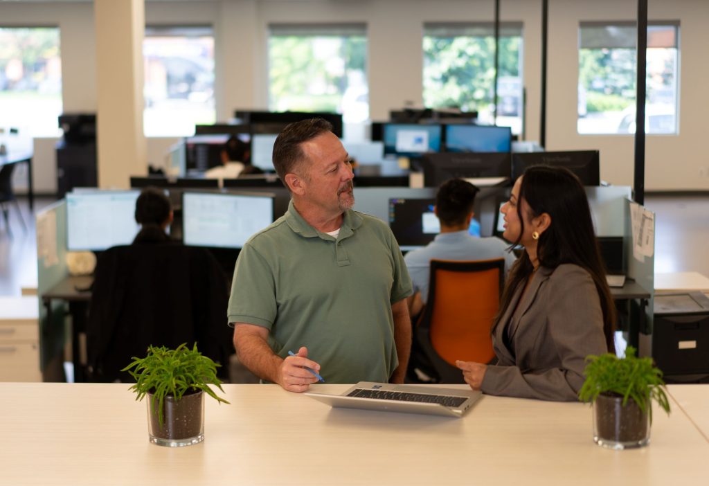 Two people standing in an office